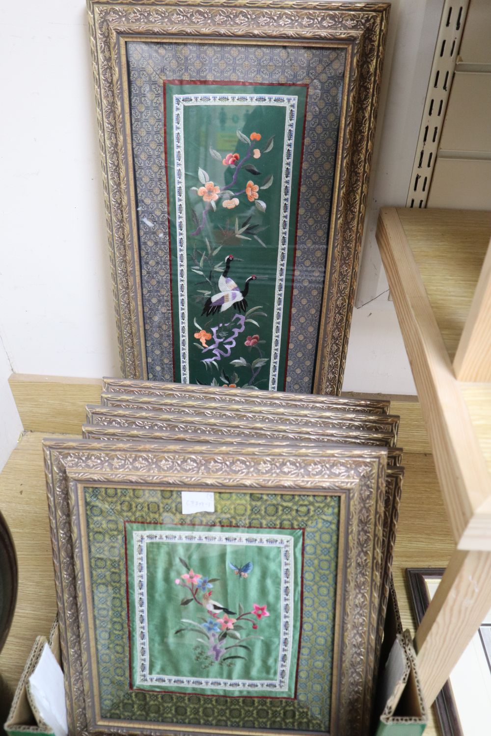 Eight Chinese embroidered silk panels, framed and glazed